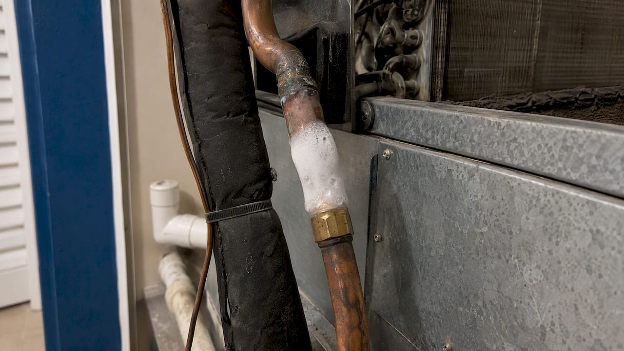 Frost forming on an air conditioner refrigerant line