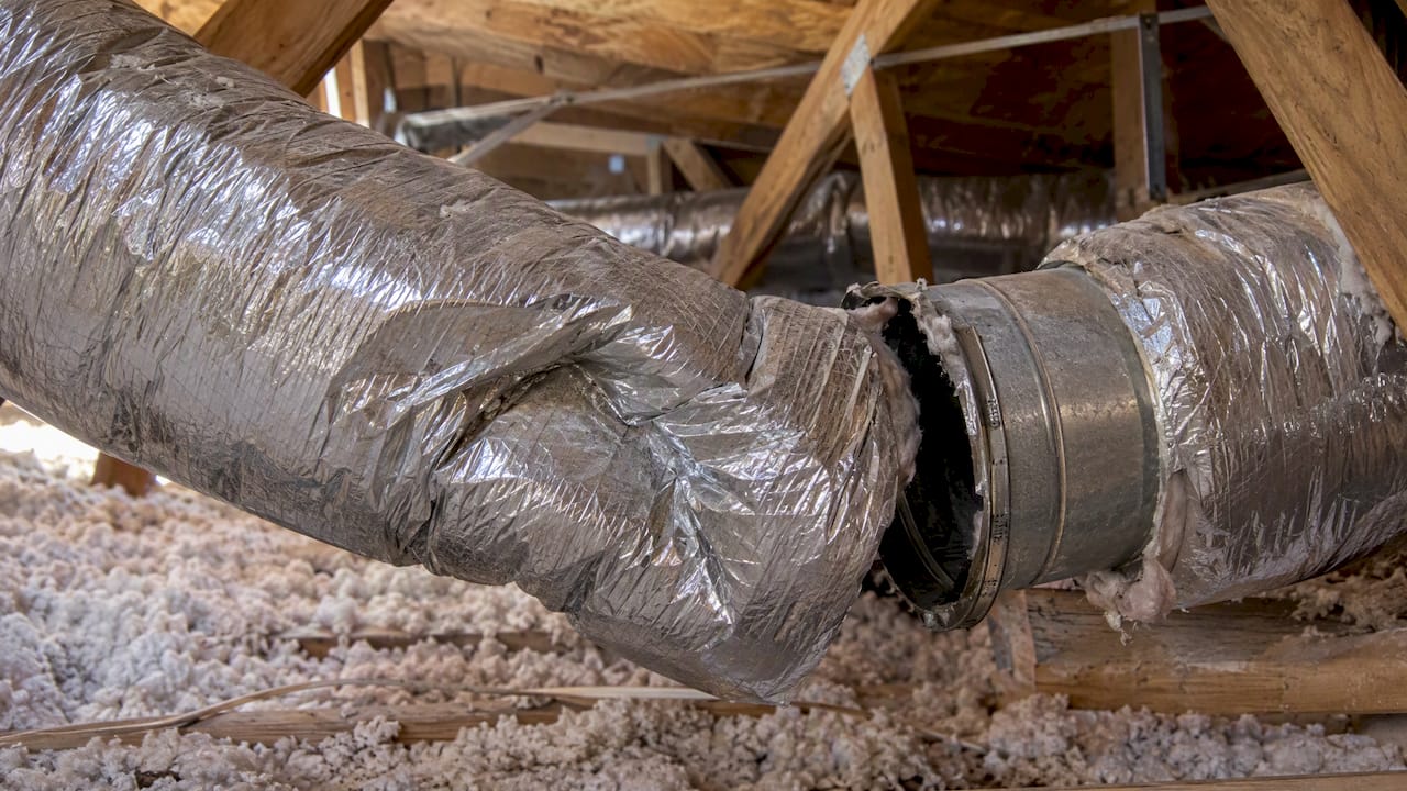 Crushed flexible duct in a home attic