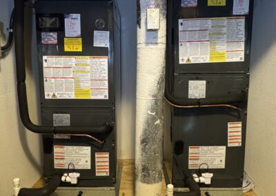 Indoor air handler in a Sarasota utility closet, with the access panel open for repair.