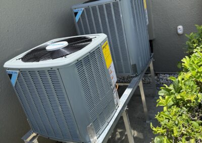 Close-up of an AC condenser fan and coil fins during an AC Heroes maintenance visit.